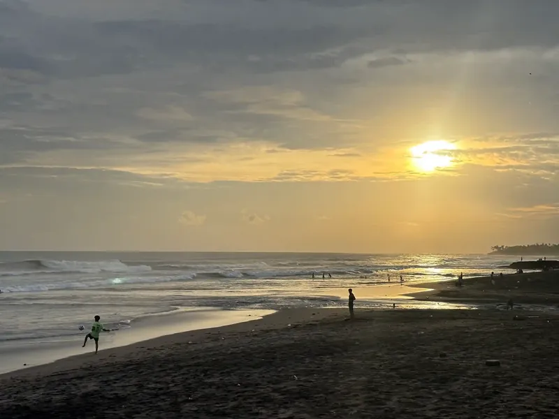 Sunset over the surf at Echo Beach, Canggu